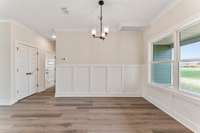 The open concept kitchen and living room aren't complete without a touch of wainscoting!