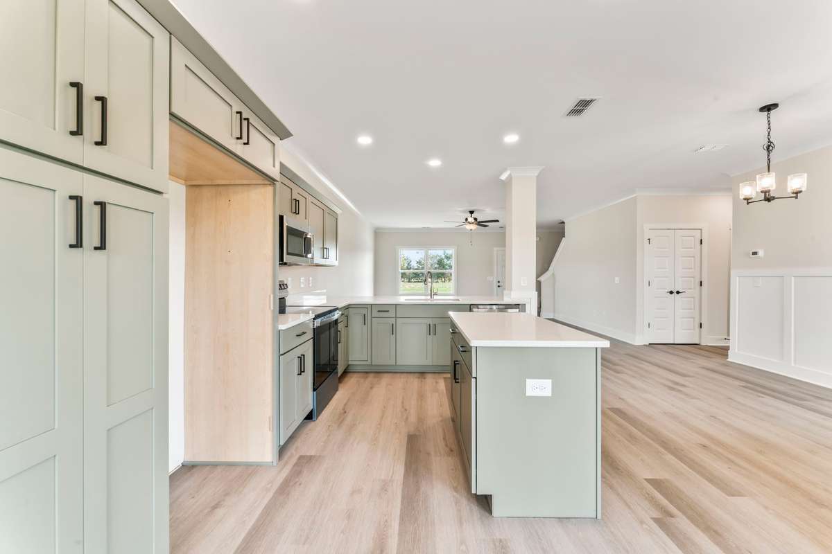 These olive-green cabinets and sparkle-white quartz go with everything! Perfect for grays or tans!