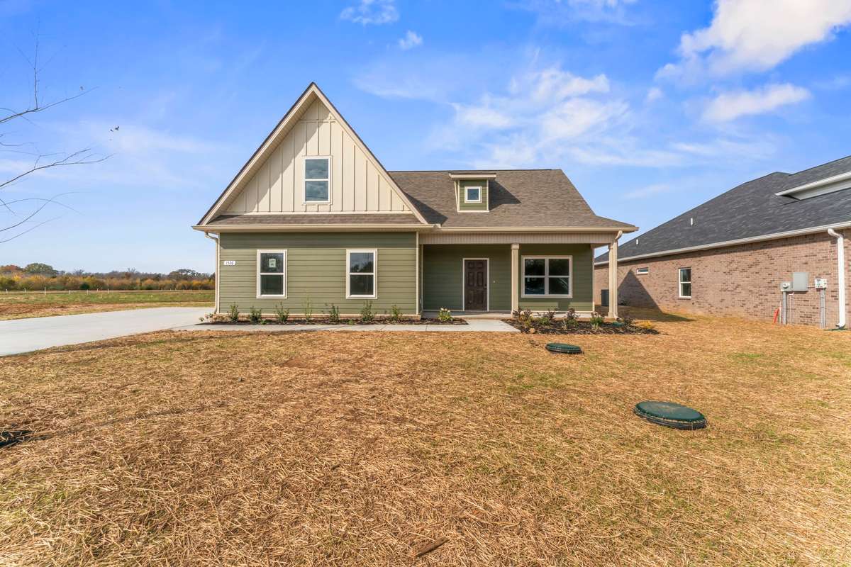 The landscaping for each home is different. This home has a variety of green shrubbery, trees and flowering plants!