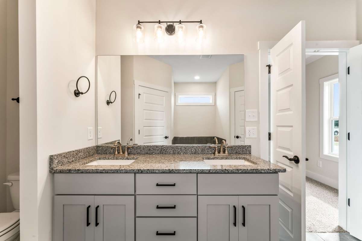 The gray cabinets and granite countertops pair perfectly with the dark floor tiles!