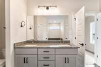 The gray cabinets and granite countertops pair perfectly with the dark floor tiles!