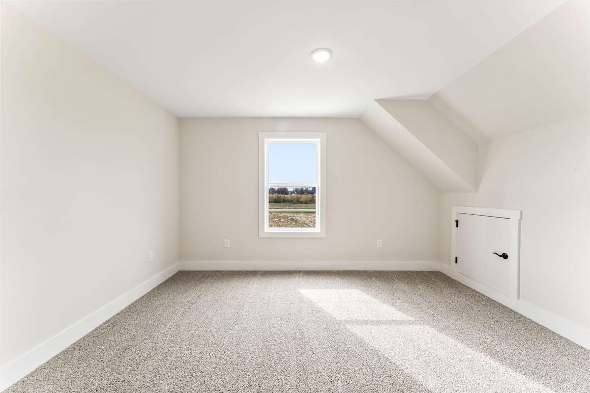 The upstairs bedroom to the left has a view of the nature trail and small attic access.