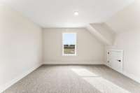 The upstairs bedroom to the left has a view of the nature trail and small attic access.