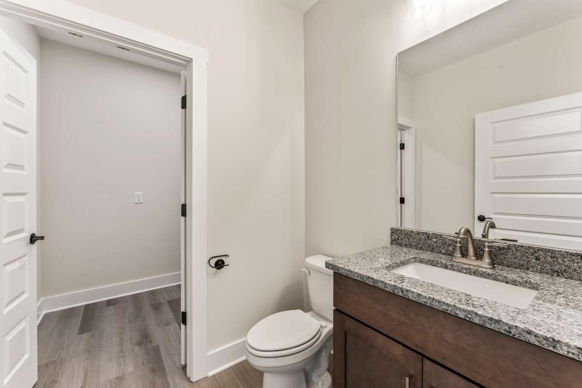 The brown cabinets with granite countertops go perfectly with the LVP flooring!