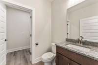 The brown cabinets with granite countertops go perfectly with the LVP flooring!
