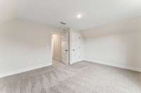 The upstairs bedroom located to the right of the stairs has plenty of room and natural light!