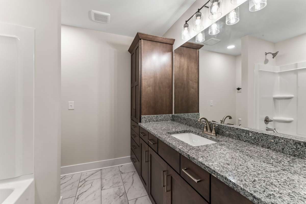 The upstairs bathroom is shared with the 2 upstairs bedrooms. The heavily-veined tile is a luxurious dream!