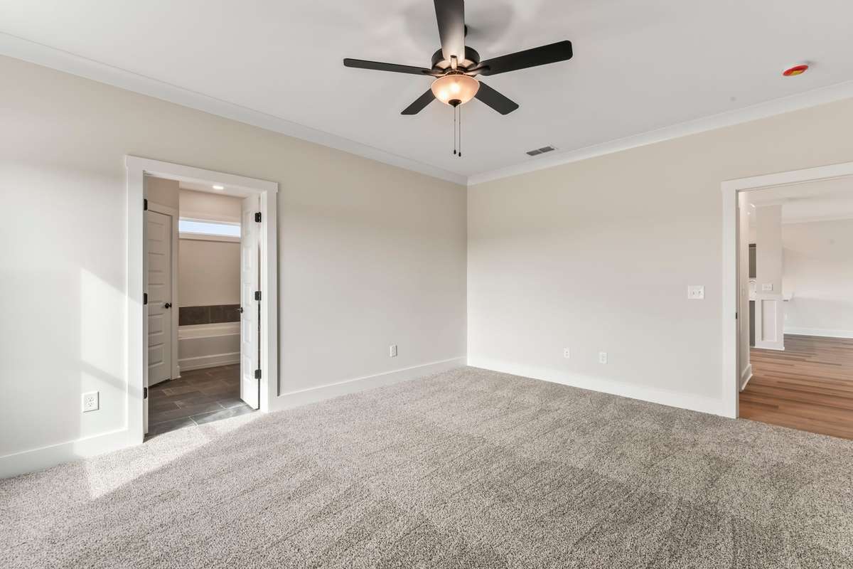 The primary bedroom is located just past the downstairs bathroom.
