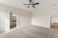 The primary bedroom is located just past the downstairs bathroom.