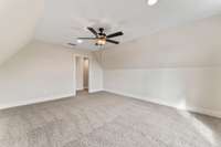 The bonus room is outfitted with a ceiling fan and wall to wall carpet!