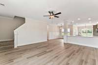 The stairs are tucked behind the front door.