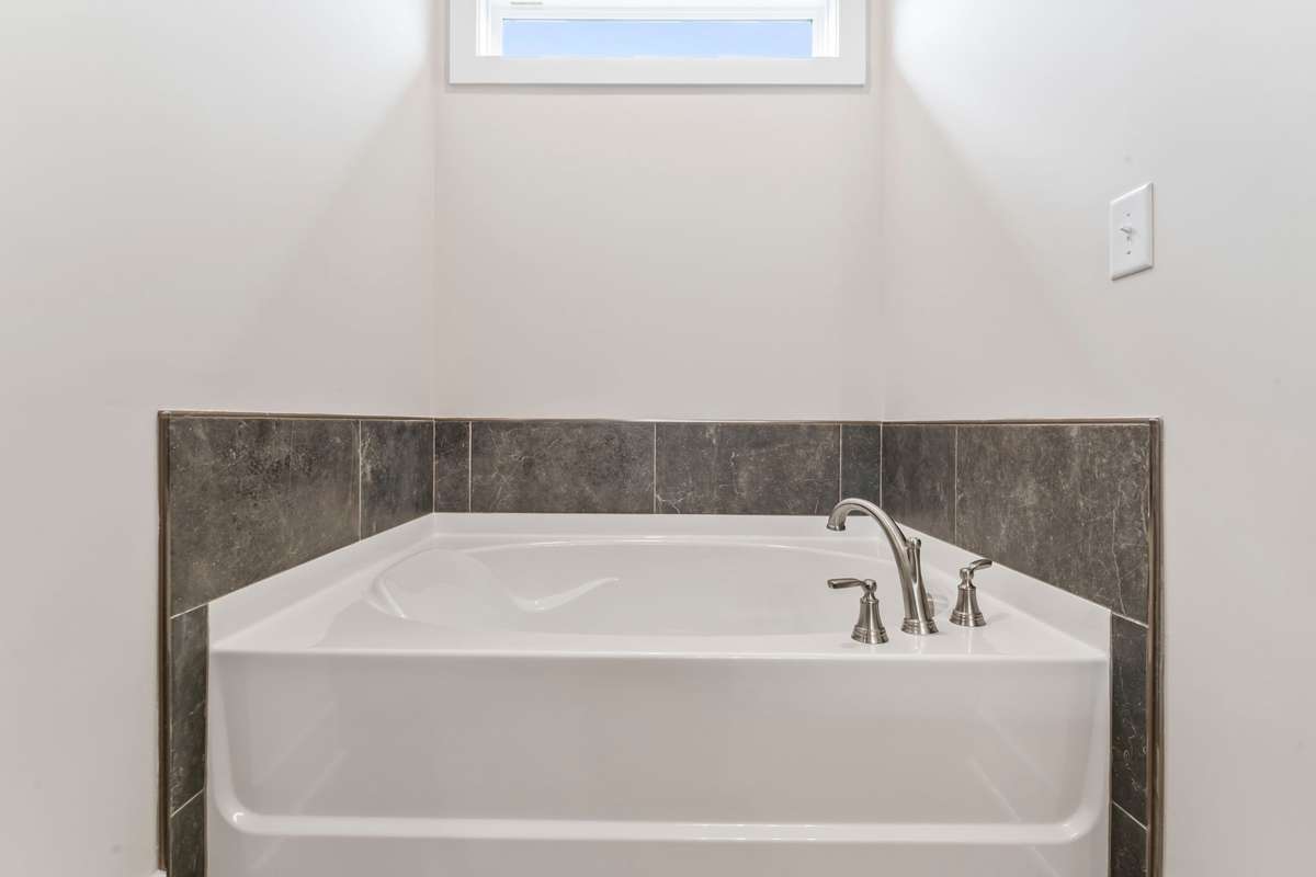 For the bath-fans, surround yourself in natural light and dark tiles to unwind!