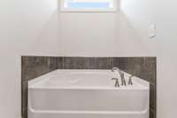 For the bath-fans, surround yourself in natural light and dark tiles to unwind!