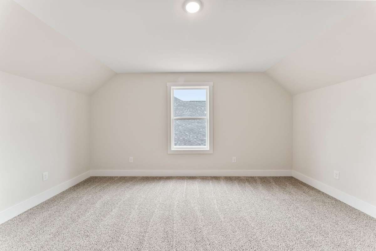 The bedroom located to the right of the stairs is perfectly symmetrical and located above the kitchen/living room.