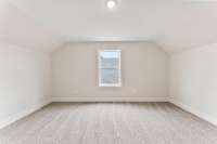 The bedroom located to the right of the stairs is perfectly symmetrical and located above the kitchen/living room.