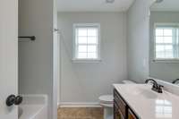 primary bath with separate tub and shower