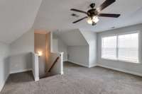 Another view of bonus room with attic storage off to the right