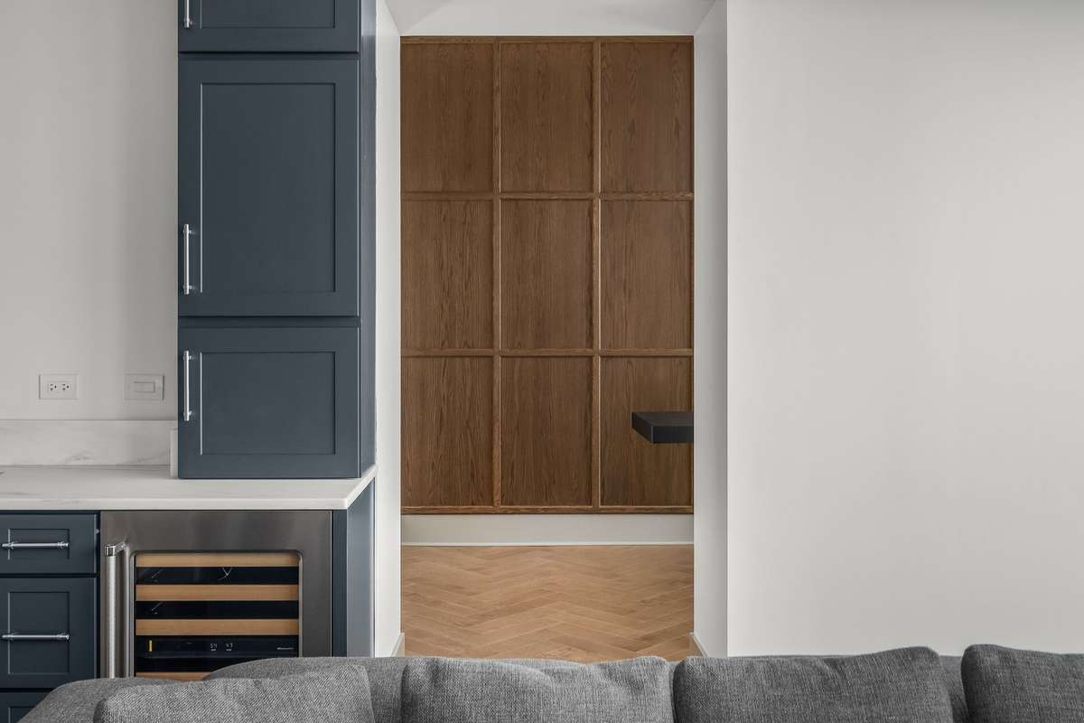 Smart functionality includes a spacious wood-paneled flex space