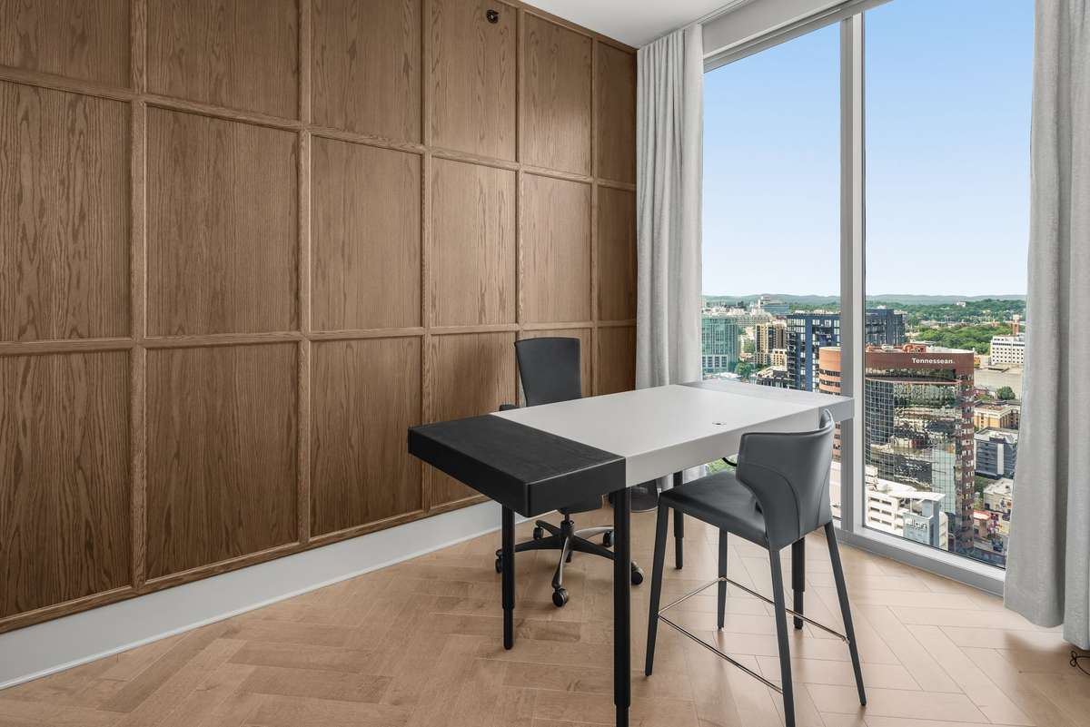 Flex space has large windows and its own half bath, perfect for a home office or guest space