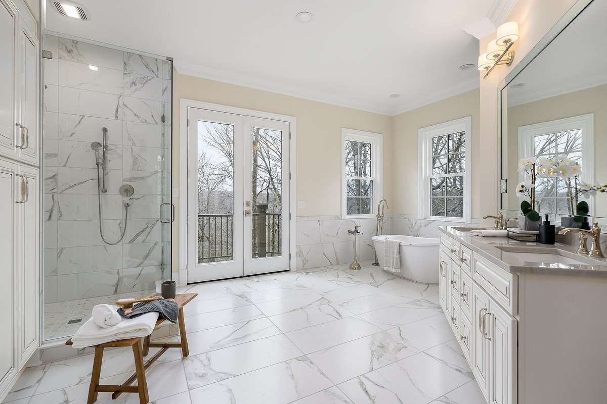 What dreams are made of! Spacious primary bath with double walk-in closets, custom tile shower, free standing tub, double vanity with Quartzite countertops, polished nickel finishes throughout, linen closet and a Juliet balcony!