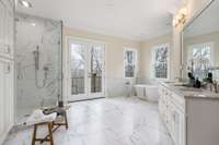 What dreams are made of! Spacious primary bath with double walk-in closets, custom tile shower, free standing tub, double vanity with Quartzite countertops, polished nickel finishes throughout, linen closet and a Juliet balcony!