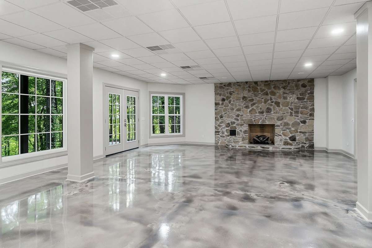 Large gathering room on lower level, gas fireplace, walk-out to covered patio with river views