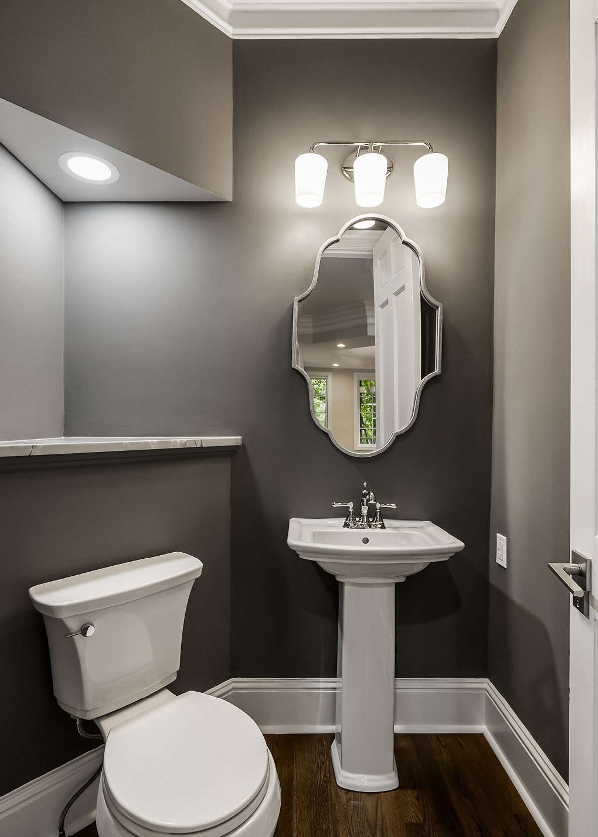 Powder room adjacent to formal living, family room and kitchen