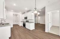 Sleek kitchen design blends style and function with ample counter space, stainless appliances, and crisp white cabinets—open to the living area for easy connection and flow.