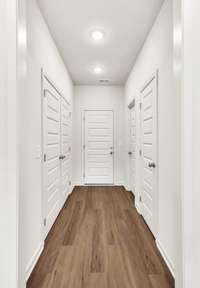 Hallway connects the laundry room, pantry, garage entry, and a large storage closet—keeping everything organized and within easy reach.