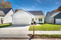 Beautiful modern home with clean lines, light Hardie Board siding, and a dark roof. Features a two-car garage, covered entry, and manicured landscaping. Low-maintenance exterior offers timeless curb appeal and lasting durability.