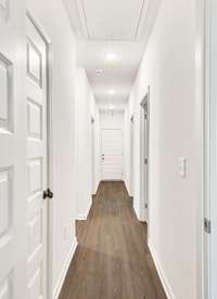 This hallway pulls the rooms together with clean lines and warm flooring that guides you straight through the heart of the home. It feels crisp and modern, but still simple enough to let the rest of the house shine.