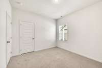 Comfortable bedroom with soft carpet, neutral palette, and standard closet—steps from bath and hallway access for convenience.