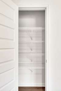 Conveniently located just off the kitchen, this pantry offers exceptional functionality and plenty of room to keep your culinary space clutter-free and efficient.