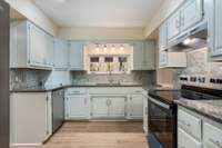 *LARGE KITCHEN WITH ALL NEW APPLIANCES INCLUDING REFRIGERATOR* TILE BACKSPLASH, GRANITE COUNTERTOPS, WINDOWS OVERLOOKING THE YARD*