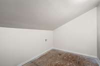 The upper level includes a spacious walk-in storage area, perfect for seasonal items or additional organization.