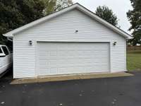 Oversized 2 Car Garage with Workshop Built ins with plenty of storage and outlets