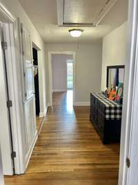 Down the hallway from the kitchen is the 2nd full bath, the utility room, and the screened in sunroom/porch!!