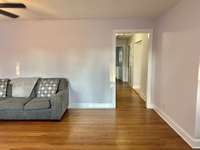 The hallway off the living room leads to three bedrooms and 1 full bath.