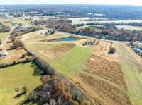 The rear property line is approximately where the woods begin, with mowed areas outlining the estimated boundaries.
