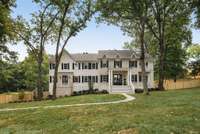 A canopy of trees surrounds this large beautiful corner lot.