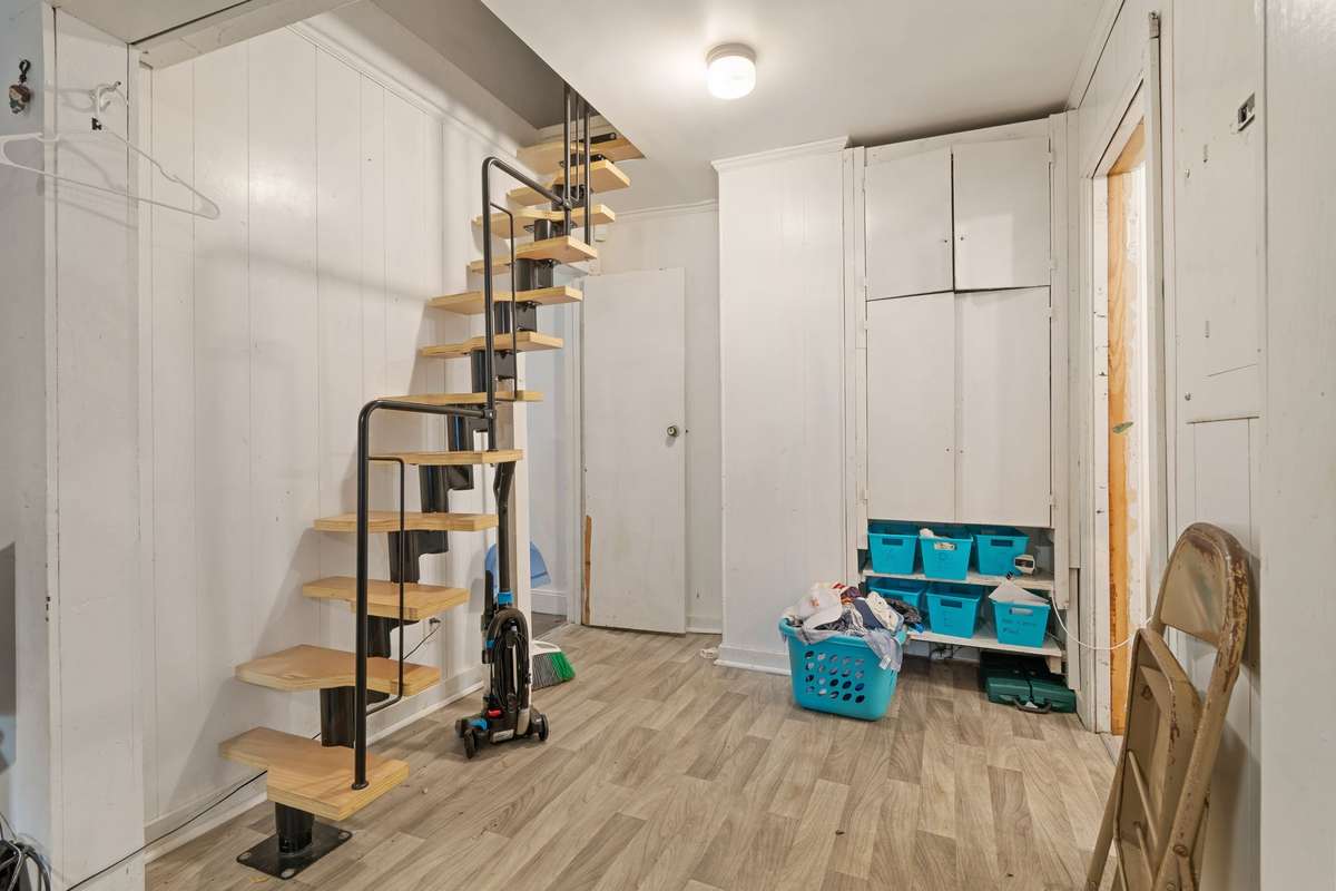 The stairs have been added for access to the attic. Could be closed up with an attic hatch put back in place if desired.
