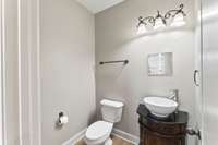 Half bath located down the hall from the main living area.