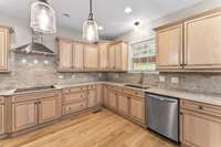 A deep farmhouse kitchen sink overlooks the greenery of the backyard.