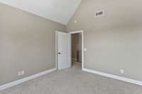 3rd bedroom with vaulted ceilings and walk-in closet.