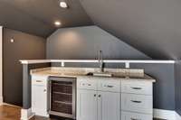 Great countertop space and ample storage in the wet bar in the recreation room