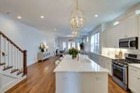 An open-concept layout allows the kitchen to flow directly into the dining and living spaces, enhancing both functionality and comfort for day-to-day living and entertaining.