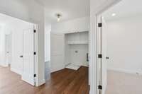 Upstairs laundry with build-in storage. Solid core doors to help eliminate noise.