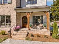Brick inlay front porch with solid wood arched front door