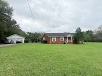 Beautiful home situated on 2 acres with 3 Bed 1.5 Baths with detached 2 car garage and carport; Lots of privacy on all sides of the property