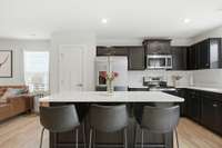 Show stopper kitchen with quartz counters and marble back splash